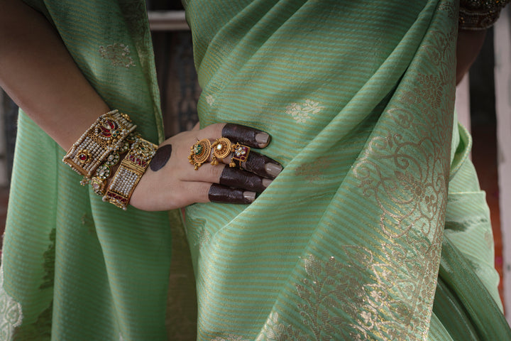 Tissue Green Taby Saree with Jari Lining, Small Flower Buttis, and Handmade Tassels